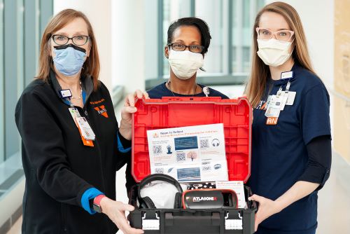 Left to right, Nancy Farish, Jeanell Webb-Jones and Jane Muir with “resiliency toolkits” for hospital units. (Photo by Kay Taylor)